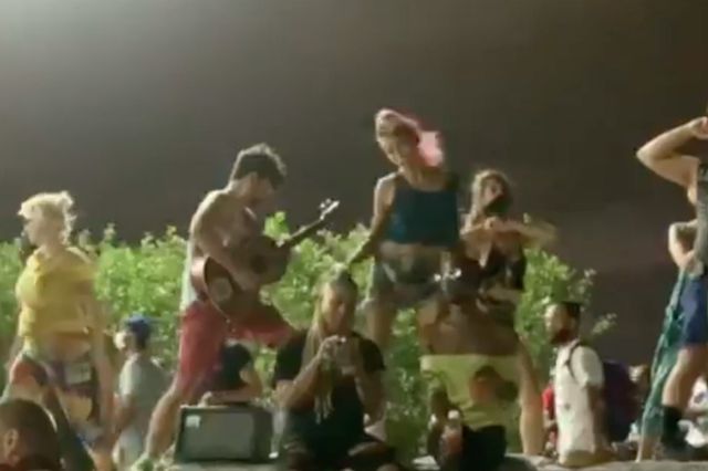 A screenshot from a video from the party, showing people dancing
